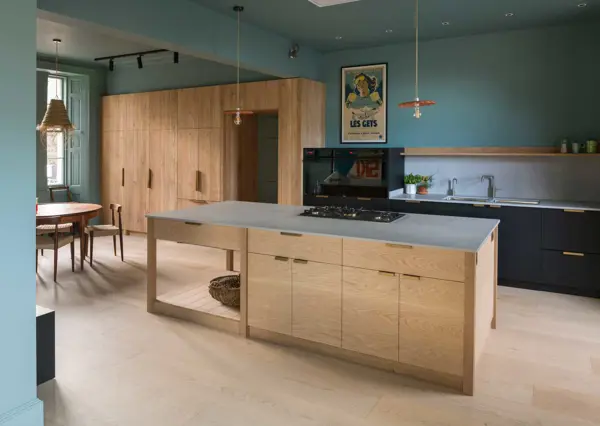A detailed view of a large kitchen island, and sink run behind where craftsmanship meets practicality in every element.