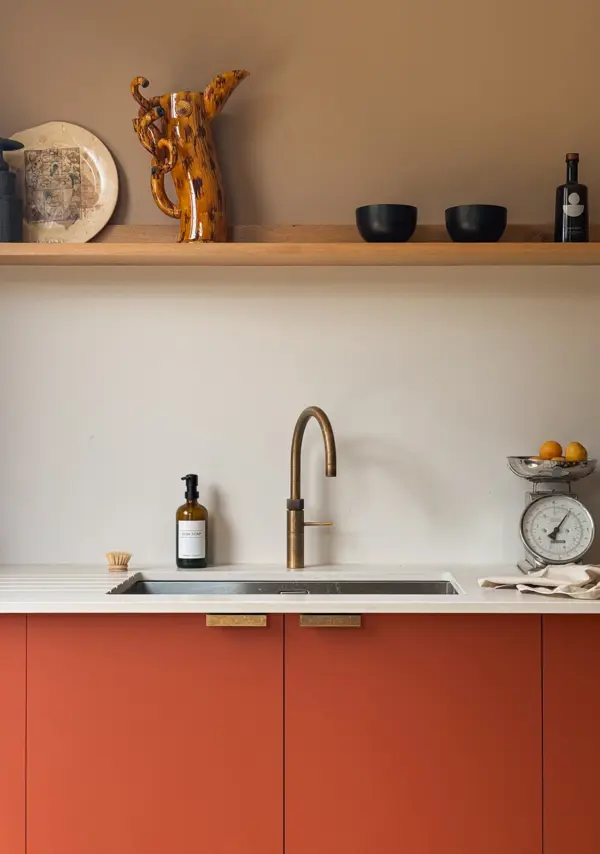 An inset stainless steel sink in contemporary red Fenix cabinetry