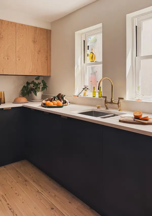 Characterful oak paired with dark Richlite kitchen cupboards and aged brass hardware