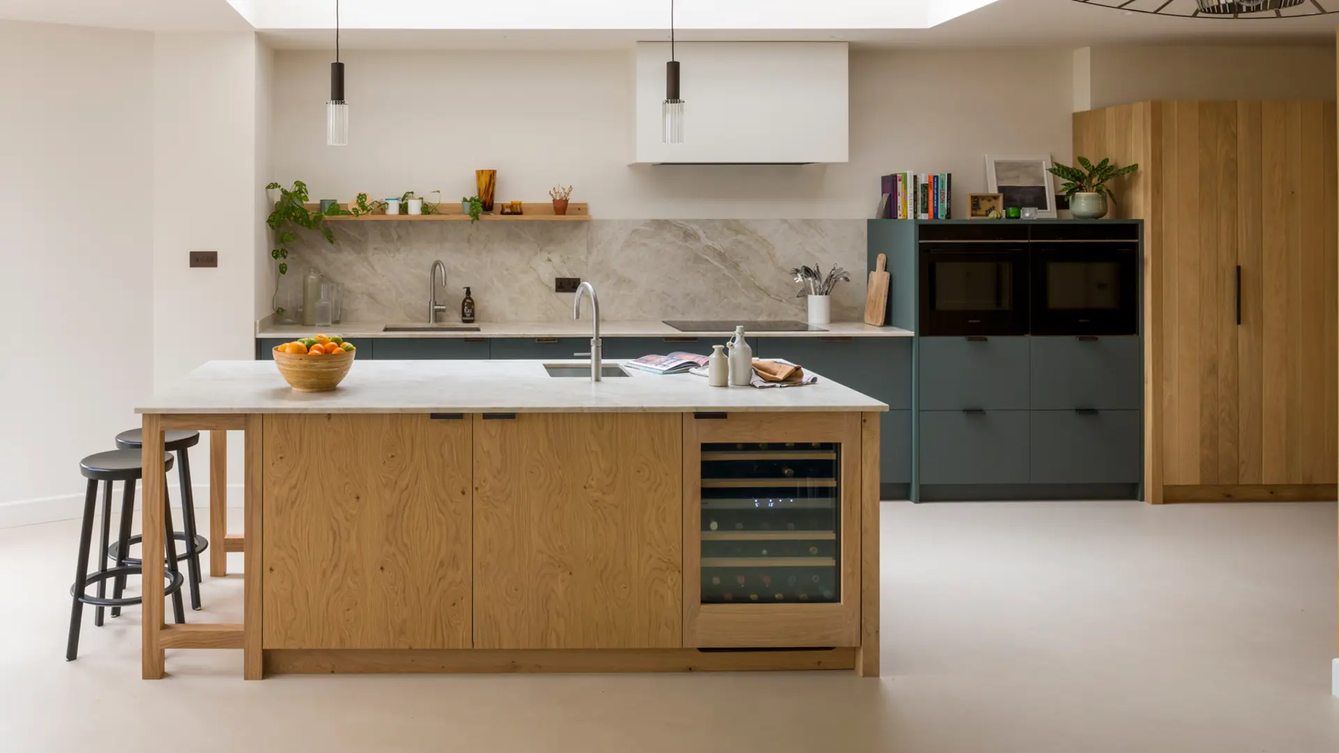 A bespoke handcrafted kitchen in Crouch End, London featuring raw band-sawn oak and smokey green Verde Comodoro Fenix cabinetry.