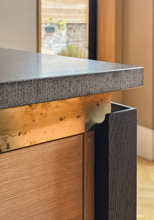 Kitchen island details: Brass, oak and granite.