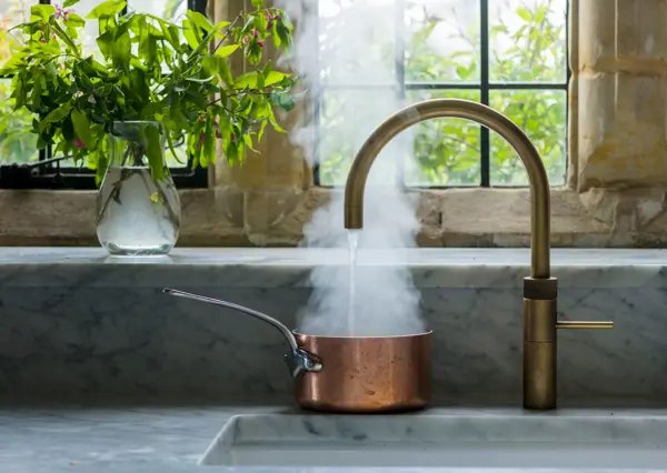 The convenience of a boiling water tap by Quooker, set within timeless Carrara Marble countertops.