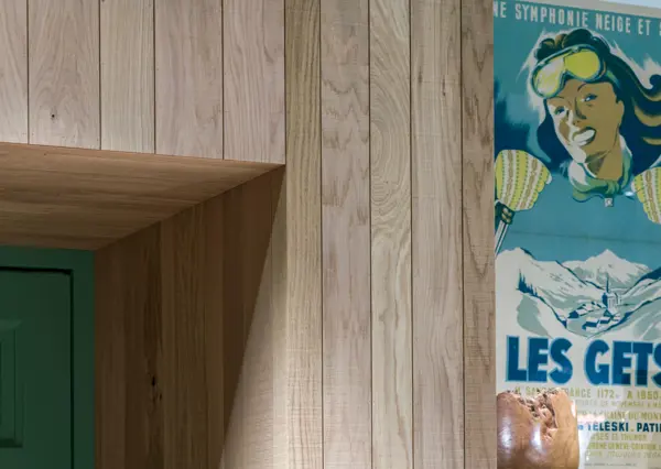 A wall of band-sawn oak conceals large kitchen appliances behind it providing a seamless and elegant kitchen design.