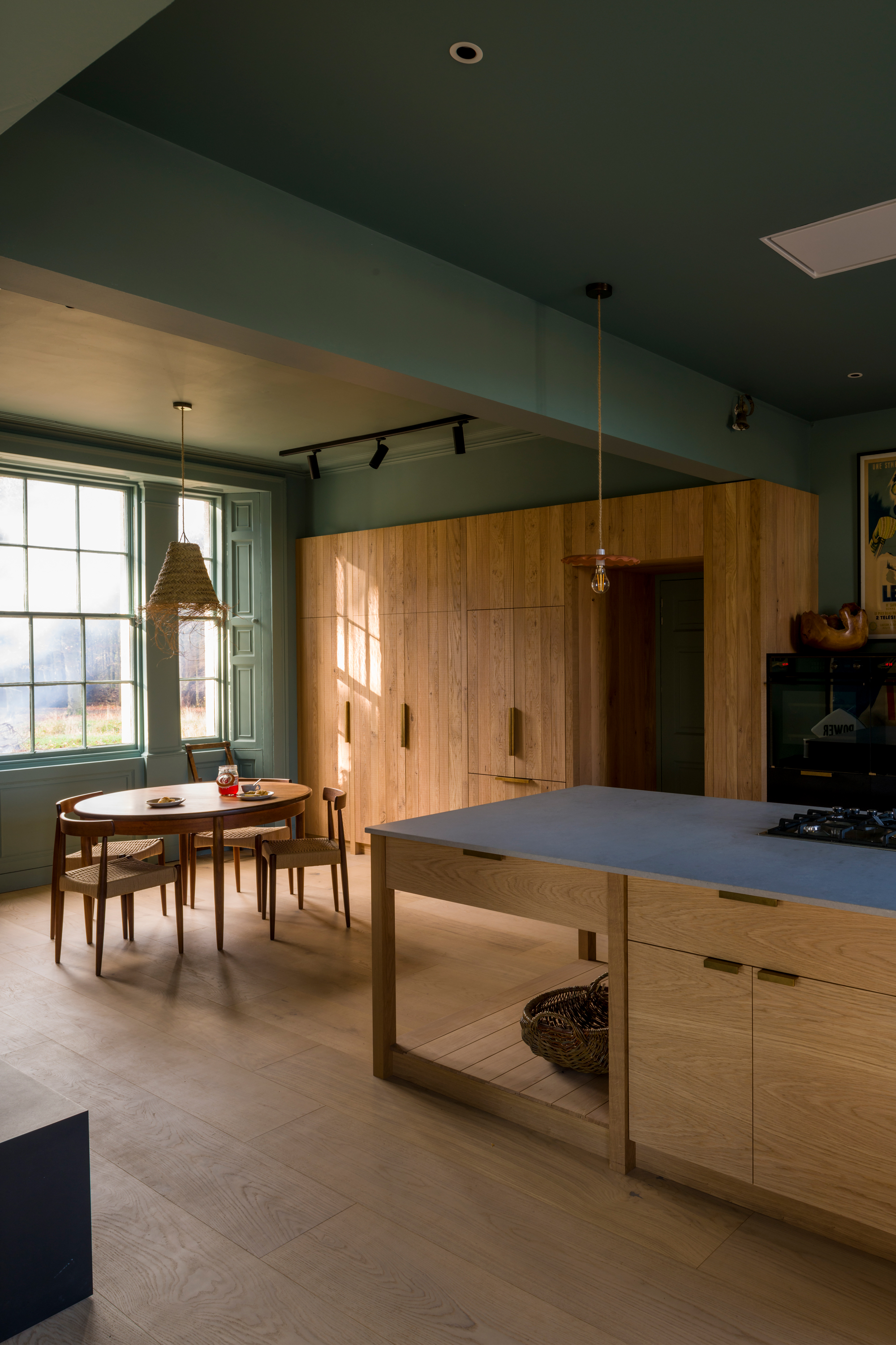 A spacious, purposefully designed open plan kitchen, with a breakfast dining area in natural tones.