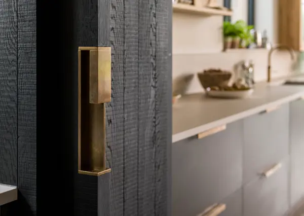 Custom designed solid brass handle for a pocket door by Ged Kennett which seamlessly leads into the utility room.