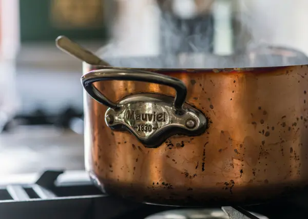 Antique French Copper pans play their part in creating the perfect kitchen for this historic period home in Sussex.
