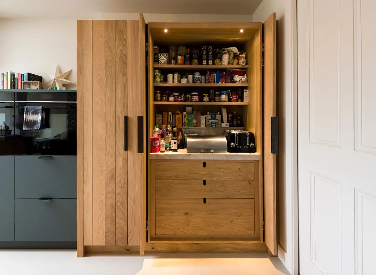 Custom made band-sawn oak with a concealed pocket door pantry, showcasing thoughtful design and enduring quality.