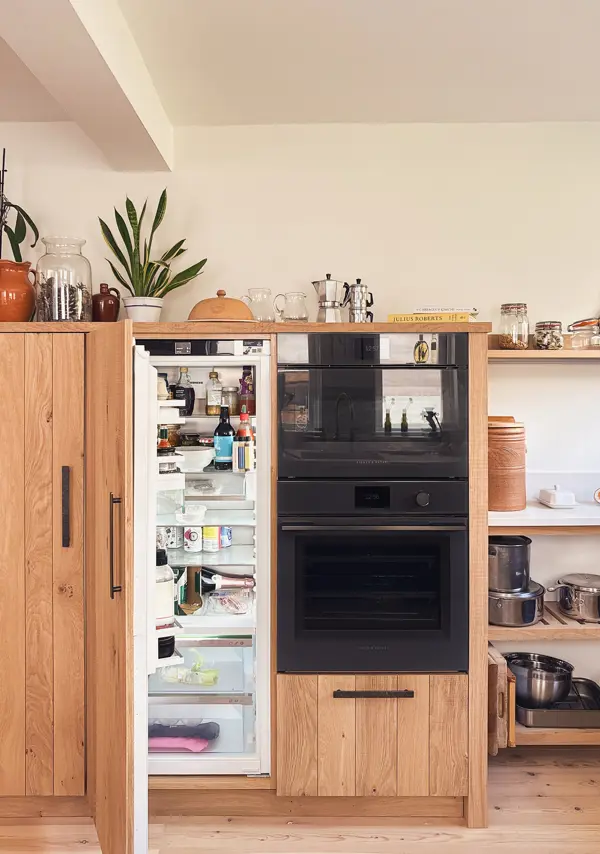 An integrated fridge hidden behind band-sawn oak doors