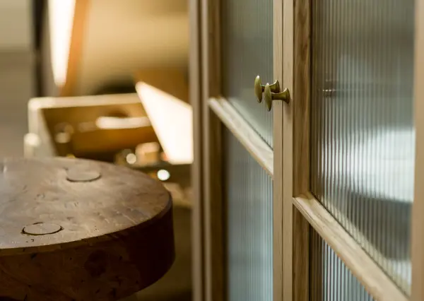 Detail of Inglis Hall bespoke oak cabinetry with brass detailing.